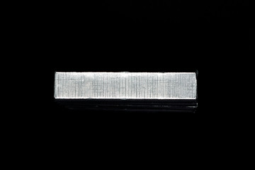 parallel chocolate bars in silver packaging on black background