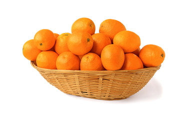 Oranges in a big wicker basket isolated on white