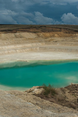 turquoise water and white shore in a kaolin quarry