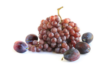 Bunches of purple grapes with plums isolated on white