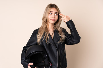 Russian girl with a motorcycle helmet isolated on beige background with problems making suicide...