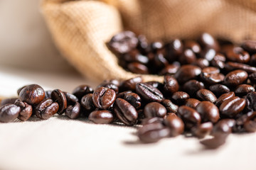 Close-up fresh roasted coffee beans in brown sack.