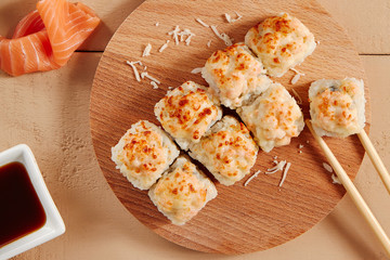 Baked shrimp rolls on wooden board top view