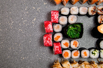 Half set of various rolls and sushi. Hats from the sauce. Baked rolls. View from above