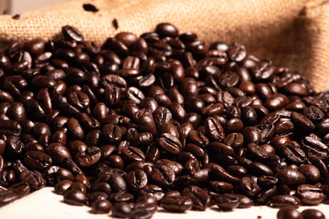 Close-up fresh roasted coffee beans in brown sack.