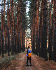 Fototapeta premium girl staying along among the autumn forest