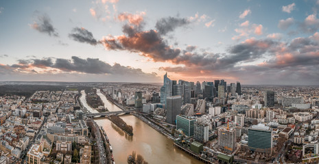 Dec 24, 2019 - Paris, France: Panoramic aerial drone shot of la defense skyscraper complex with clouds during sunset hour