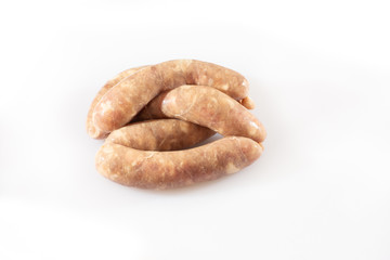 Raw pork beef sausages on white background. Traditional German homemade sausages. Delicious raw meat for barbecue. Advertising for meat shop and farm. Top view. Space for text