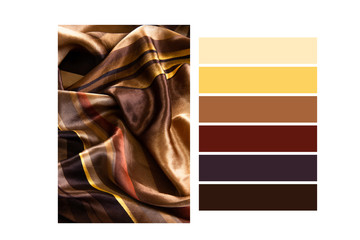 Folded silk golden tone cloth in a colour palette, with complimentary colour swatches