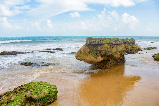Beach with coral rock and boat in blue sea and cloud sky. Beach with coral rock and boat in blue sea and cloud sky