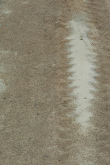tire tread track on wet sand