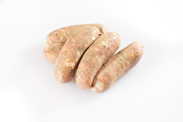 Raw pork beef sausages on white background. Traditional German homemade sausages. Delicious raw meat for barbecue. Advertising for meat shop and farm. Top view. Space for text
