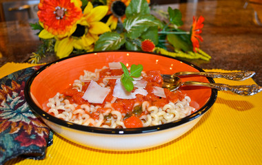 Marinara sauce on a bowl of elbow macaroni
