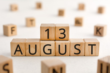 August 13 - from wooden blocks with letters, important date concept, white background random letters around