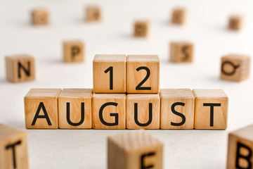 August 12 - from wooden blocks with letters, important date concept, white background random letters around