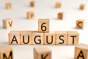 August 6 - from wooden blocks with letters, important date concept, white background random letters around