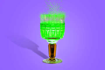 magic potion green sparks in a crystal glass blue background