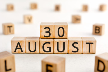 August 30 - from wooden blocks with letters, important date concept, white background random letters around