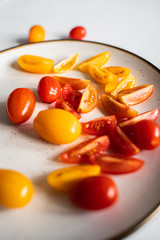 Cut tomatoes on white plate