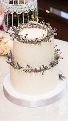 Elegant wedding cake decorated with flowers and succulents.