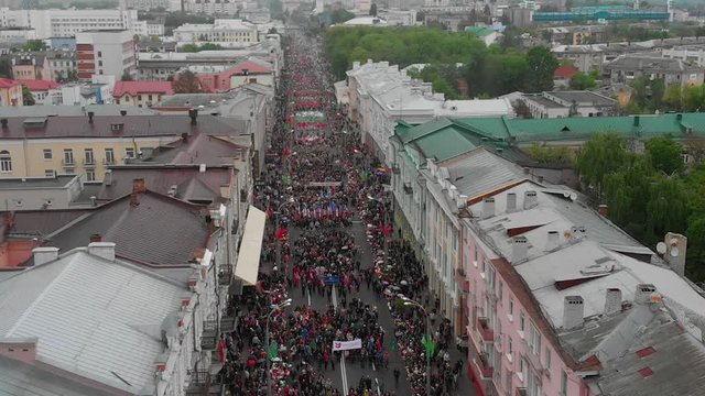 Gomel, Belarus - 05/09/2019: Festive procession on Victory Day, flight over the roofs of the city, many people downstairs