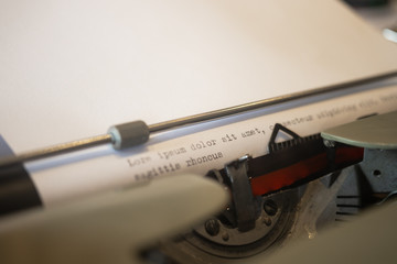 Fototapeta premium Close-up of a retro typing machine. Close-up of someone writing on an old vintage writing machine.