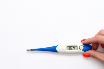 a girl holds an electronic thermometer on a white background, normal temperature
