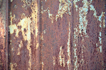Rusty old metal surface with the remains of blue paint.