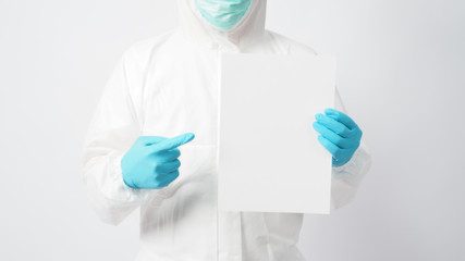 Male model with PPE suite and Hand with glove is holding A4 paper on white background.