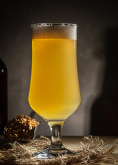 Glass of homemade beer on a wooden table. Glass of craft beer on a dark background.