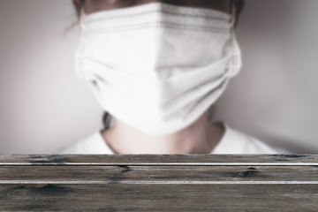 Empty table with COVID-19 mask background. Mockup photography. Presentation for products.