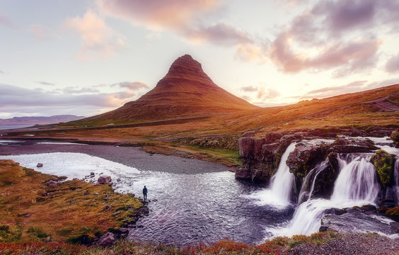 Scenic image of Iceland. Great view on famouse Mount Kirkjufell with Kirkjufell waterfall with colorful sky during sunset. Wonderful Nature landscape. Iconic location for landscape photographers © jenyateua