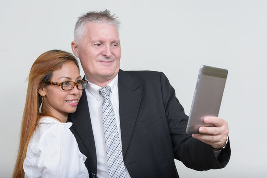 Happy mature multi ethnic business couple working together