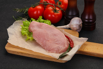 Raw Turkey steak served rosemary