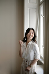 A girl is spraying perfume