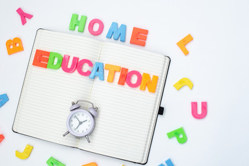 Colored letters of the English alphabet and a notebook on a white background. Children education