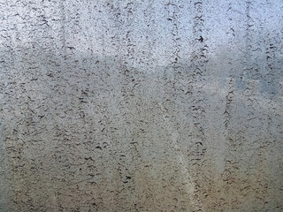 Dirty old windshield on the bus with a faint background.