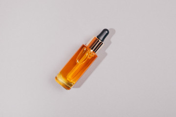 Skincare bottle orange container. Flat lay style.