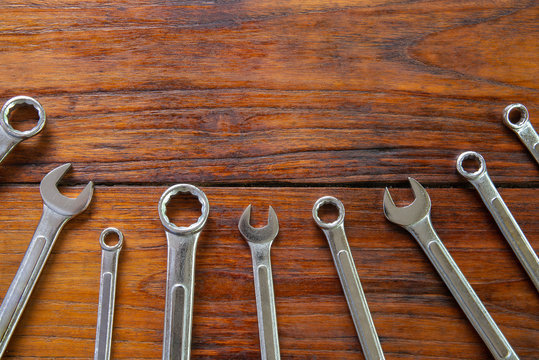 Metal bunch wrench  tools lying on dark wooden background
