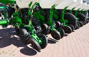 A close-up on agricultural farm machinery, sowing drill mechanical seeder and fertilizer machine...