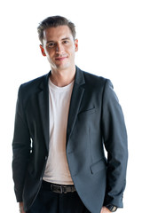 Portrait of a young confident handsome businessman in white T-shirt and dark jacket looking at the camera. Isolated on white background.