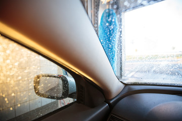Car in a carwash being washed (shallow DOF; color toned image)