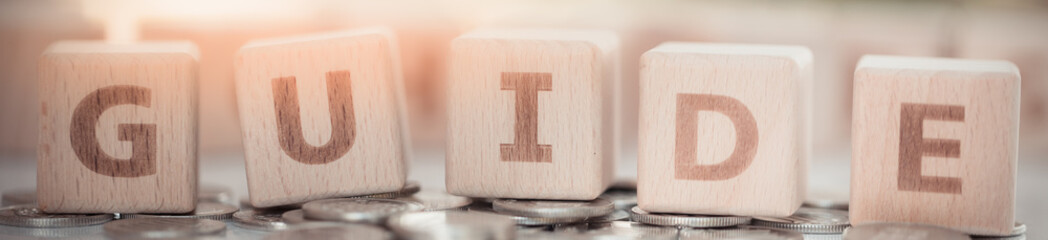 Wood block word GUIDE and copy space using as background business, tour concept.
