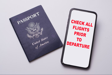 Travel warning on a cell phone with a passport for international travel