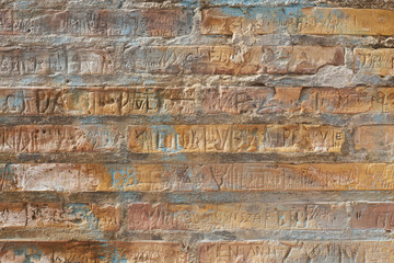 Brick wall with carved in names. Rich texture for background, wallpaper etc.  Pattern frontal square straight on.
