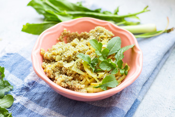 Quinoa grain cereal porridge with herbs in bowl. Vegan food