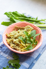 Quinoa grain cereal porridge with herbs in bowl. Vegan food