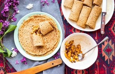 Crepes rolls with apples fruits or thin sweet pancakes. Homemade vegan dessert.
