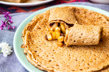 Crepes rolls with apples fruits or thin sweet pancakes. Homemade vegan dessert.