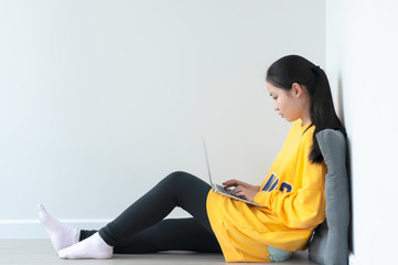 Coronavirus crisis, Asian female teenager use 18 years old do online learning from home by laptop,...